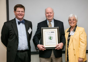 Monte (center) receives award from Stephen Hansen and Carol Aten